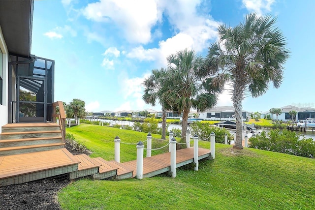 view of community with a lawn, a water view, and a residential view