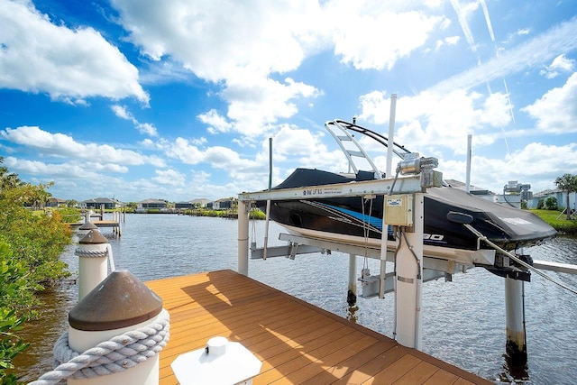 dock area with a water view and boat lift