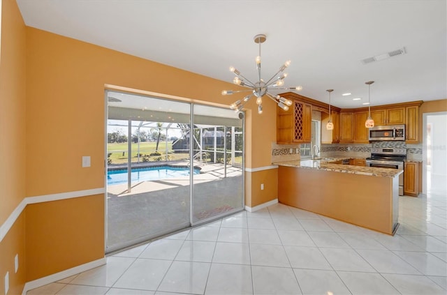 kitchen featuring visible vents, appliances with stainless steel finishes, a sink, a healthy amount of sunlight, and backsplash