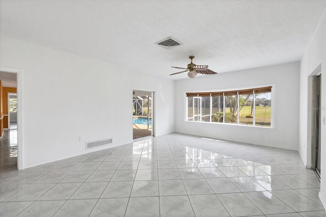 unfurnished room with light tile patterned floors, ceiling fan, a textured ceiling, and visible vents