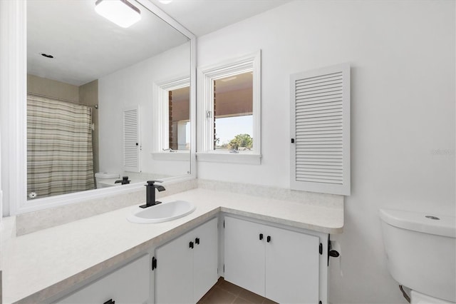 full bathroom featuring toilet and vanity