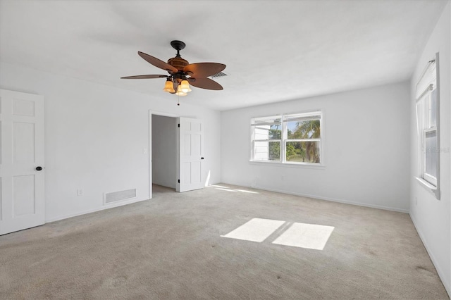 carpeted empty room featuring visible vents