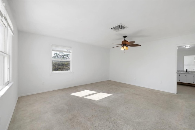 unfurnished room with light colored carpet and visible vents