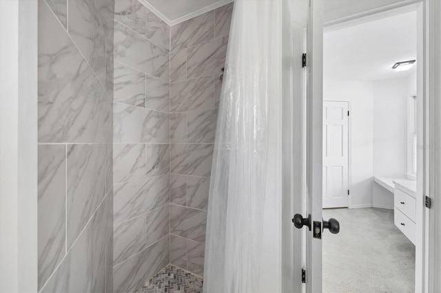 full bathroom with tiled shower and vanity