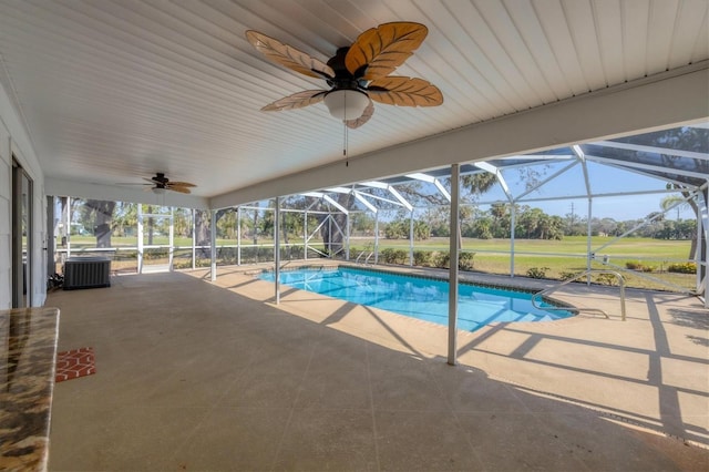 pool with glass enclosure, ceiling fan, cooling unit, and a patio