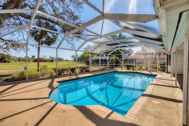 pool featuring glass enclosure and a patio