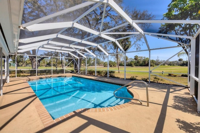 outdoor pool with a lanai, a patio area, and a yard