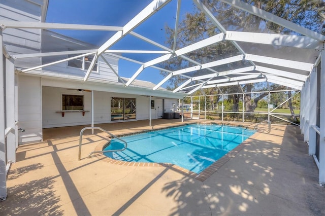 pool with a patio area, a lanai, and a ceiling fan