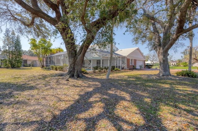 view of yard featuring a lanai