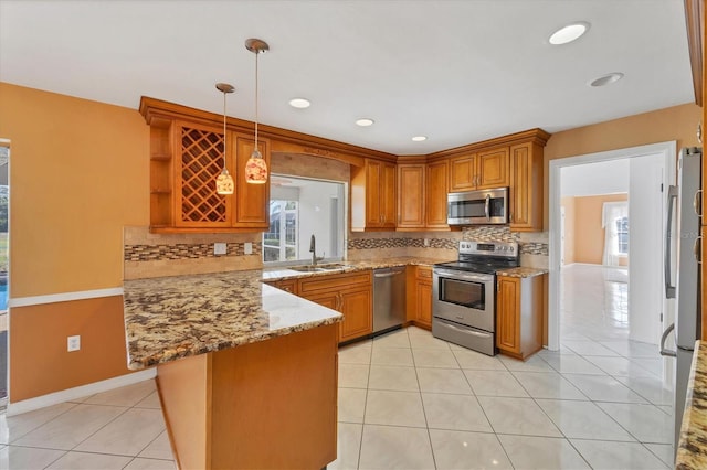 kitchen with open shelves, light stone countertops, a sink, a peninsula, and stainless steel appliances