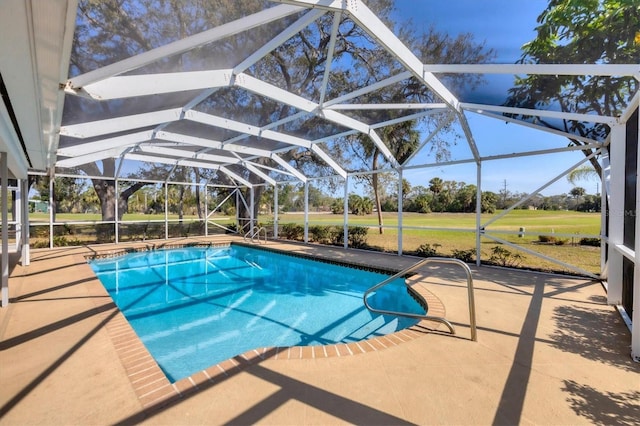 pool with a lanai, view of golf course, and a patio area