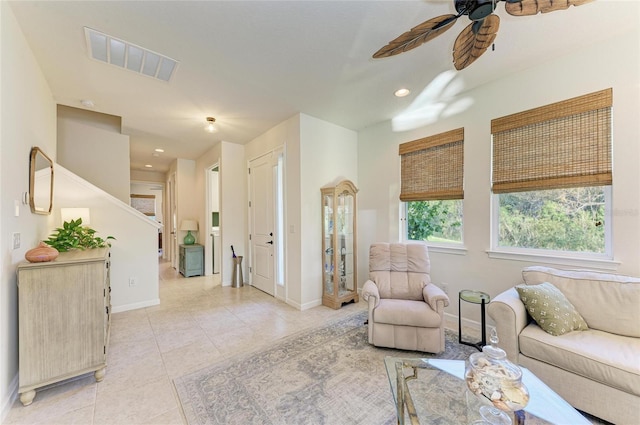 living area featuring ceiling fan, light tile patterned flooring, recessed lighting, visible vents, and baseboards