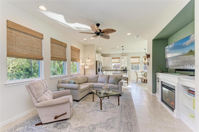 living area featuring a wealth of natural light, visible vents, recessed lighting, and light tile patterned flooring