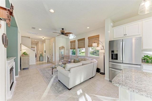 living room featuring light tile patterned floors, visible vents, a ceiling fan, and recessed lighting