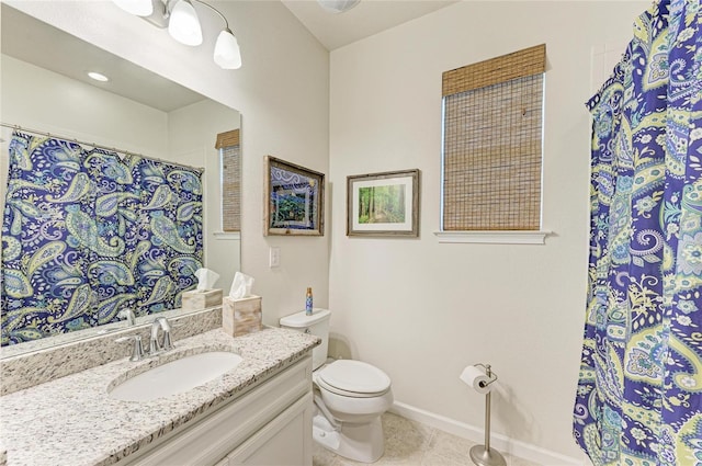 bathroom with toilet, a shower with shower curtain, vanity, baseboards, and tile patterned floors