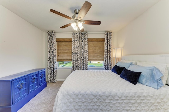 carpeted bedroom with a ceiling fan and baseboards