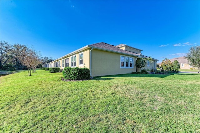 view of property exterior featuring a lawn and stucco siding