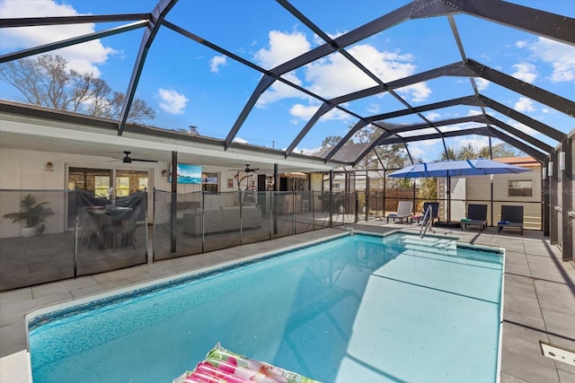 view of pool with a lanai, a patio area, ceiling fan, and a fenced in pool