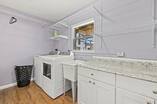 laundry room with baseboards, light wood-style flooring, and washer and dryer