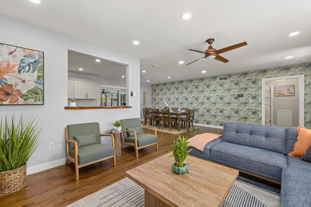 living area with recessed lighting, wood finished floors, visible vents, baseboards, and wallpapered walls