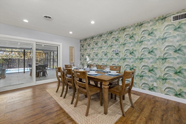 dining area featuring recessed lighting, visible vents, wood finished floors, baseboards, and wallpapered walls