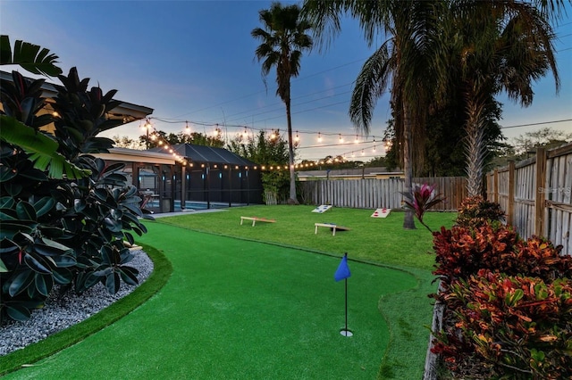 surrounding community with a fenced backyard, a lawn, and a swimming pool