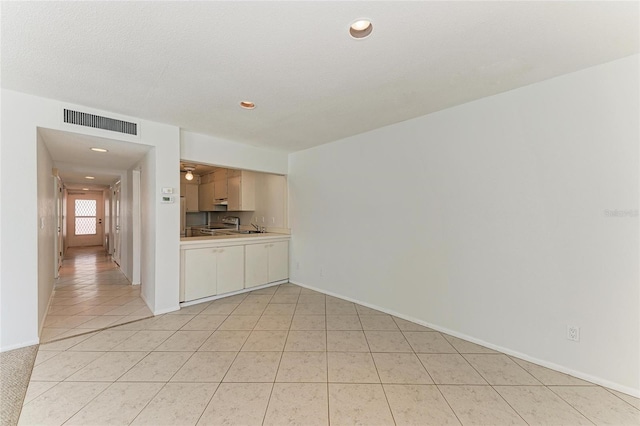 interior space featuring light tile patterned floors, baseboards, visible vents, and recessed lighting