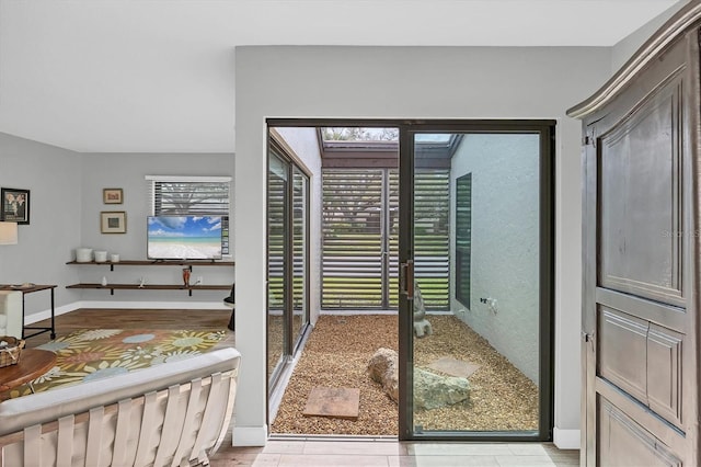 entryway with french doors and baseboards