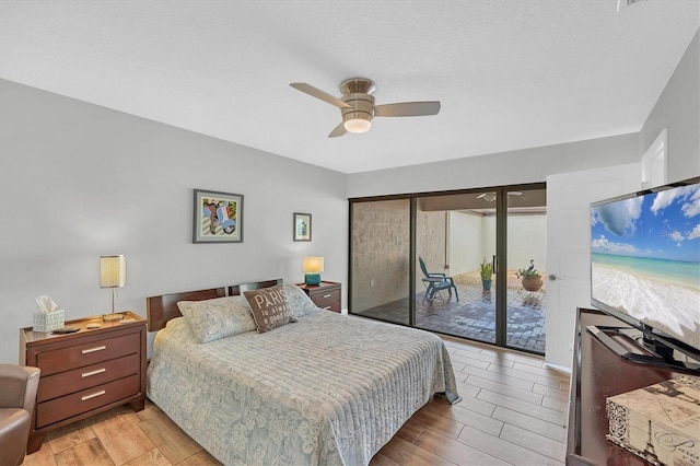 bedroom with access to outside, a ceiling fan, and wood finish floors