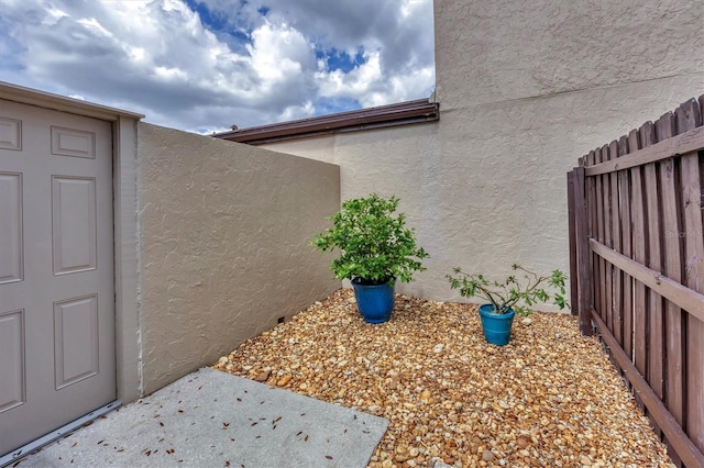 view of home's exterior featuring fence and stucco siding