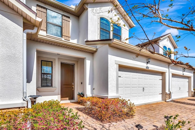 view of front of home featuring a garage and stucco siding