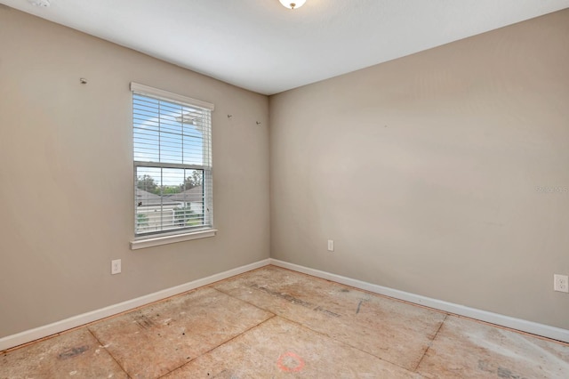 unfurnished room featuring baseboards