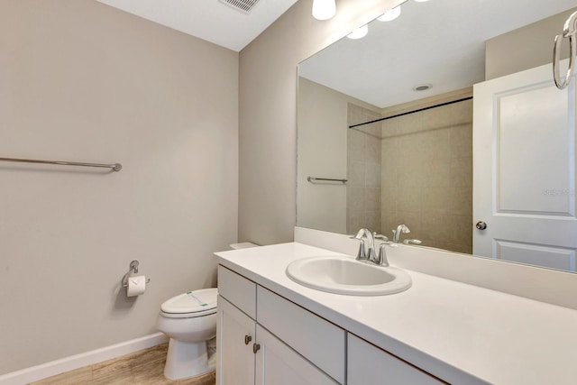 full bath with visible vents, toilet, vanity, wood finished floors, and baseboards