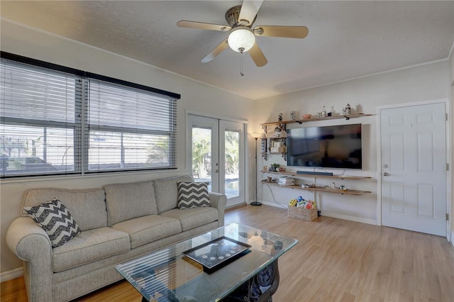 living area featuring a ceiling fan, french doors, and wood finished floors