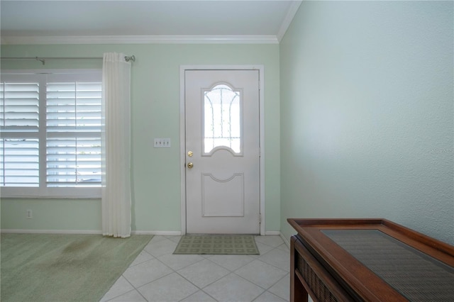 tiled entryway featuring baseboards and ornamental molding