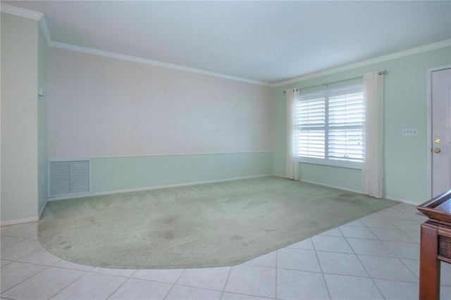 tiled spare room featuring baseboards, carpet, visible vents, and crown molding