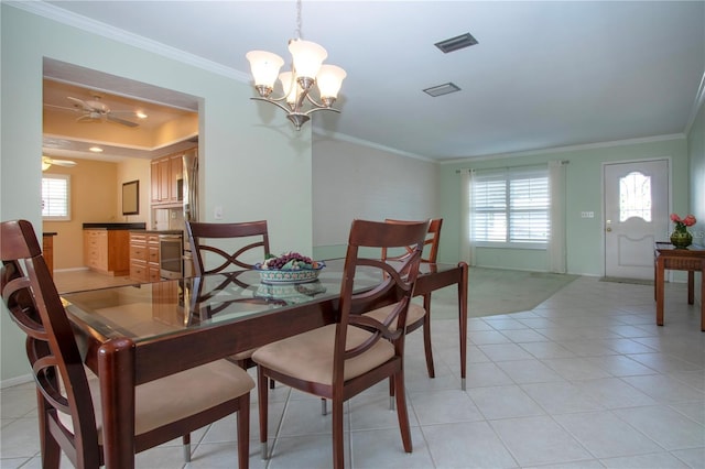 dining space with baseboards, ornamental molding, visible vents, and a healthy amount of sunlight