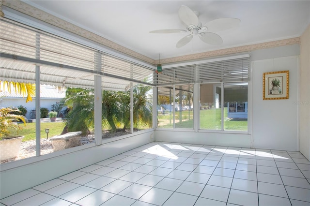 unfurnished sunroom with ceiling fan