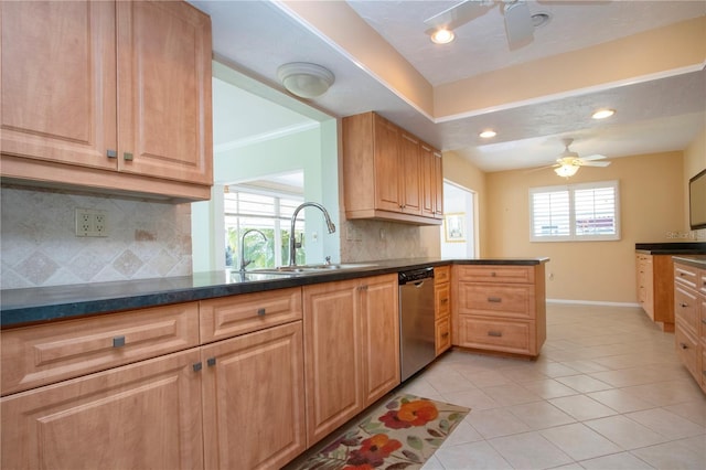 kitchen with light tile patterned floors, dark countertops, a sink, dishwasher, and a peninsula