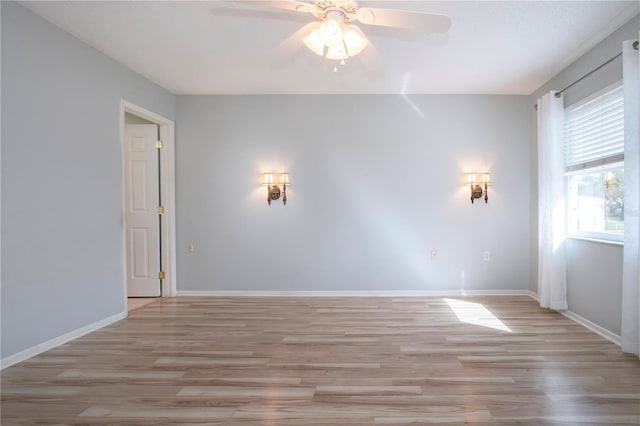 unfurnished room with light wood-type flooring, ceiling fan, and baseboards