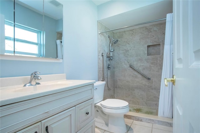 bathroom featuring visible vents, toilet, a tile shower, vanity, and tile patterned floors