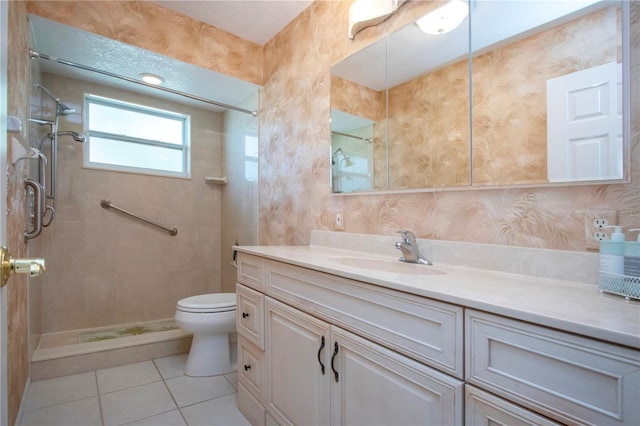 full bath featuring toilet, tiled shower, and vanity