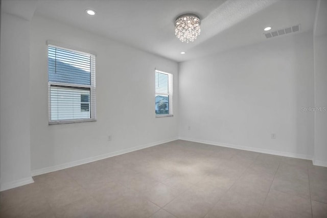 spare room featuring an inviting chandelier, baseboards, visible vents, and recessed lighting