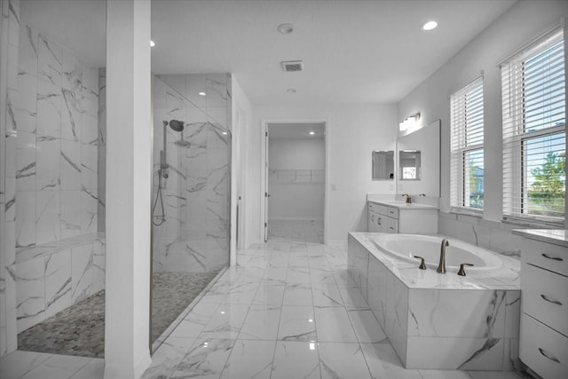 bathroom featuring a marble finish shower, visible vents, a walk in closet, vanity, and a bath