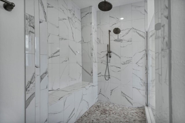 bathroom featuring a marble finish shower