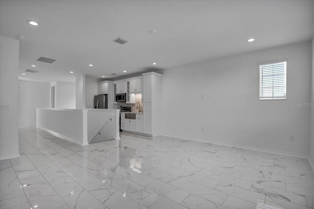 unfurnished living room featuring recessed lighting, marble finish floor, and visible vents