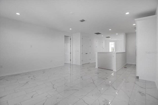 unfurnished room with baseboards, marble finish floor, visible vents, and recessed lighting