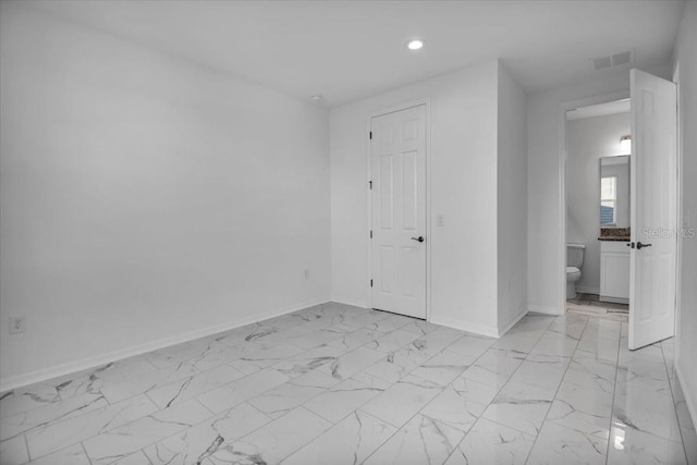 spare room featuring recessed lighting, marble finish floor, visible vents, and baseboards