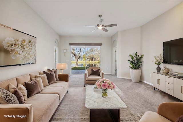 living room featuring a ceiling fan, carpet flooring, and baseboards