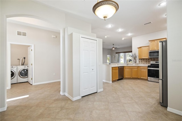 kitchen featuring appliances with stainless steel finishes, light countertops, visible vents, and washer and clothes dryer